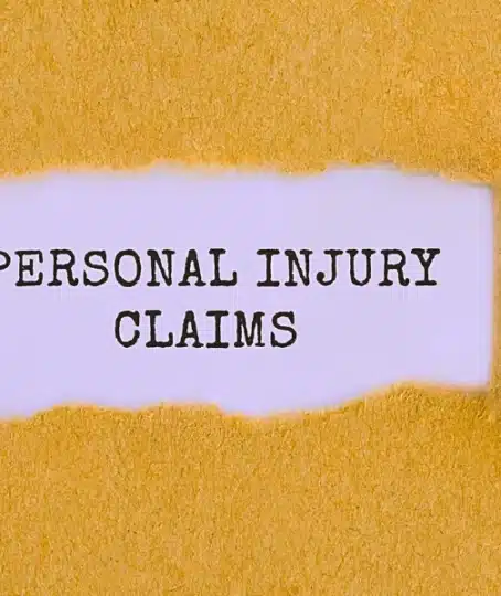Text Personal Injury Claims appearing behind ripped brown paper. personal injury claim process